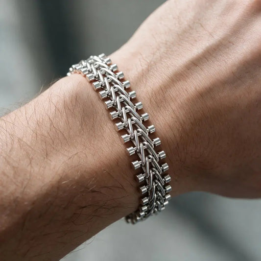 Silver riveted flat mesh chain bracelet worn on the wrist