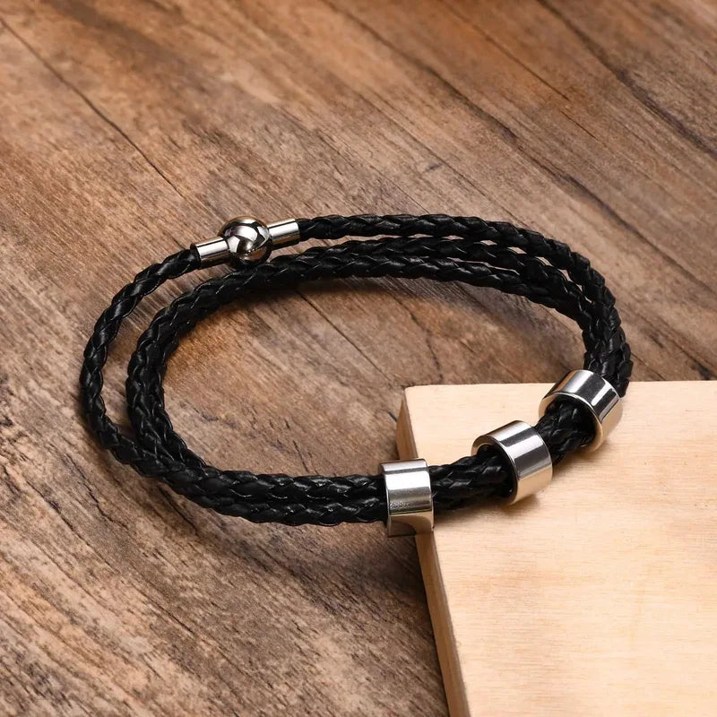 Lineage braided leather bracelet with stainless steel beads on wood surface