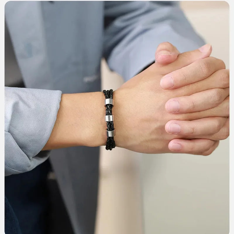 Close-up of hands clasped wearing the Lineage family names bracelet