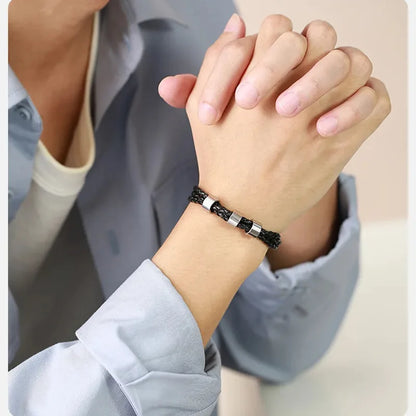 Close-up of hands clasped wearing the Lineage bracelet, alternate angle