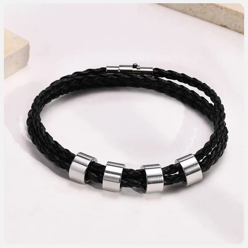 Lineage bracelet coiled, showing multiple engraved name beads