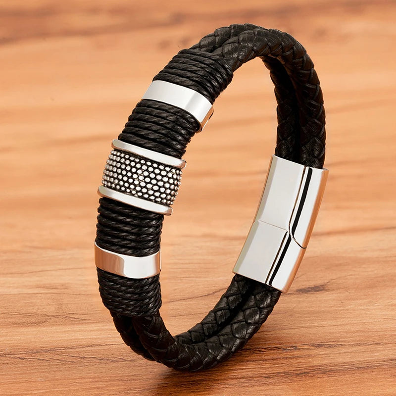 Close-up of a black woven leather rope bracelet with steel rondelle beads worn on the wrist