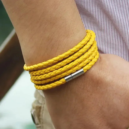 Yellow braided leather bracelet wrapped five times around the wrist