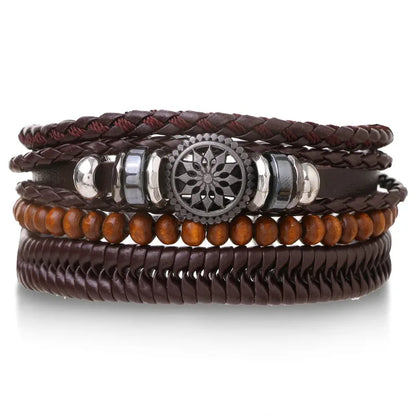 Brown leather layered bracelet stack with a mandala charm, wood beads, and a herringbone band, on a white background.