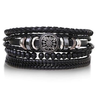 Black leather layered bracelet stack with a mandala charm, black wood beads, and braided strands, on a white background.