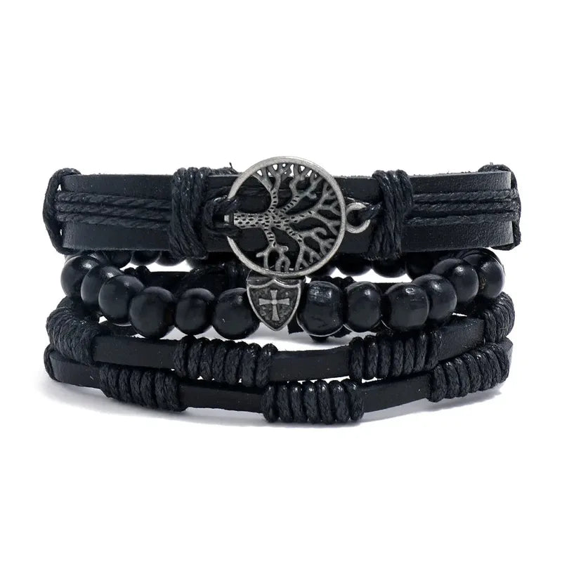 Black leather layered bracelet stack with a tree of life charm and a small cross shield charm, black wood beads, on a white background.