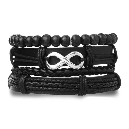 Black leather layered bracelet stack with wood beads, a braided strand, and a silver infinity charm, on a white background.