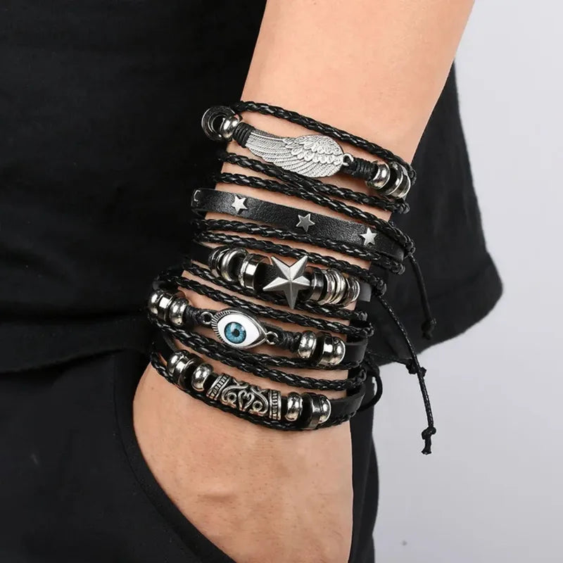 Five-piece evil eye leather bracelet stack worn on the wrist, paired with black clothing.