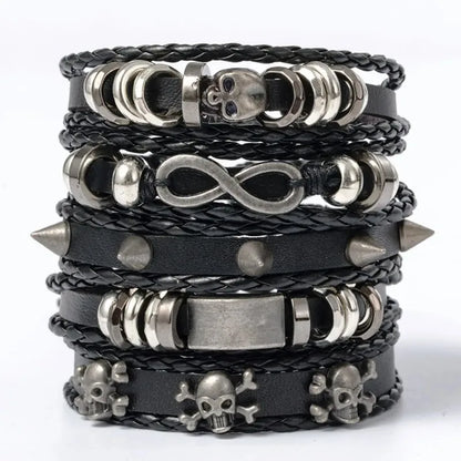 Five-piece black leather bracelet stack with a skull bead, infinity charm, and studded rivet band, on a white background.