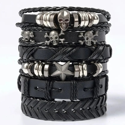 Six-piece black leather bracelet stack with a silver skull bead, skull-and-crossbones charms, and a star bead, on a white background.
