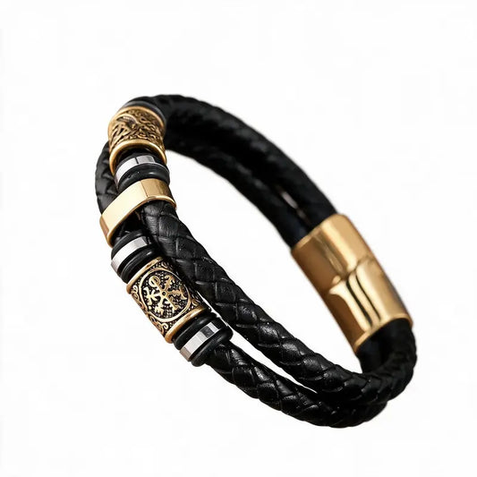 Black braided leather bracelet with gold-tone engraved Norse rune beads and a magnetic clasp, on a white background.