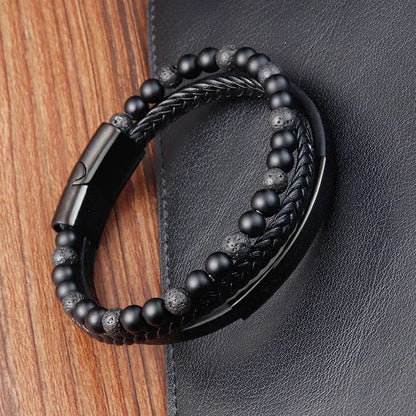 Multi-strand leather bracelet with black lava rock beads, on a white background