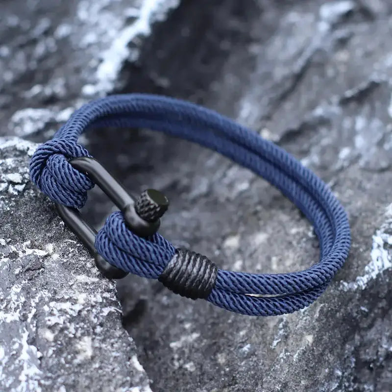 Men Bracelet Rope – Helm Shackle Rope Bracelet in navy, worn outdoors on rocks