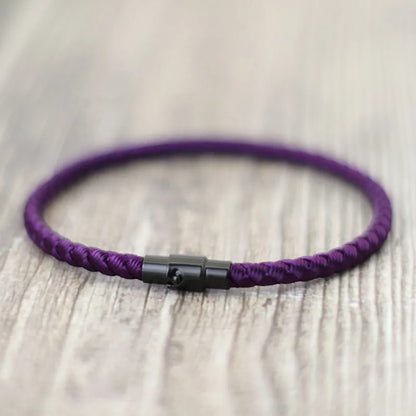 Purple braided cord bracelet with a black stainless steel barrel clasp