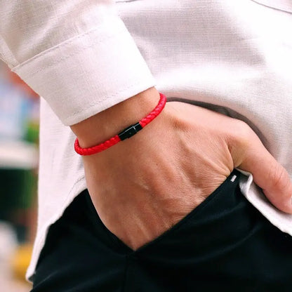 Red braided cord bracelet worn on the wrist