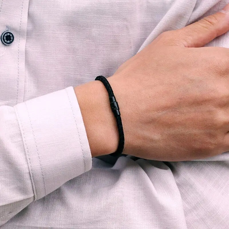 Black braided cord bracelet worn on the wrist