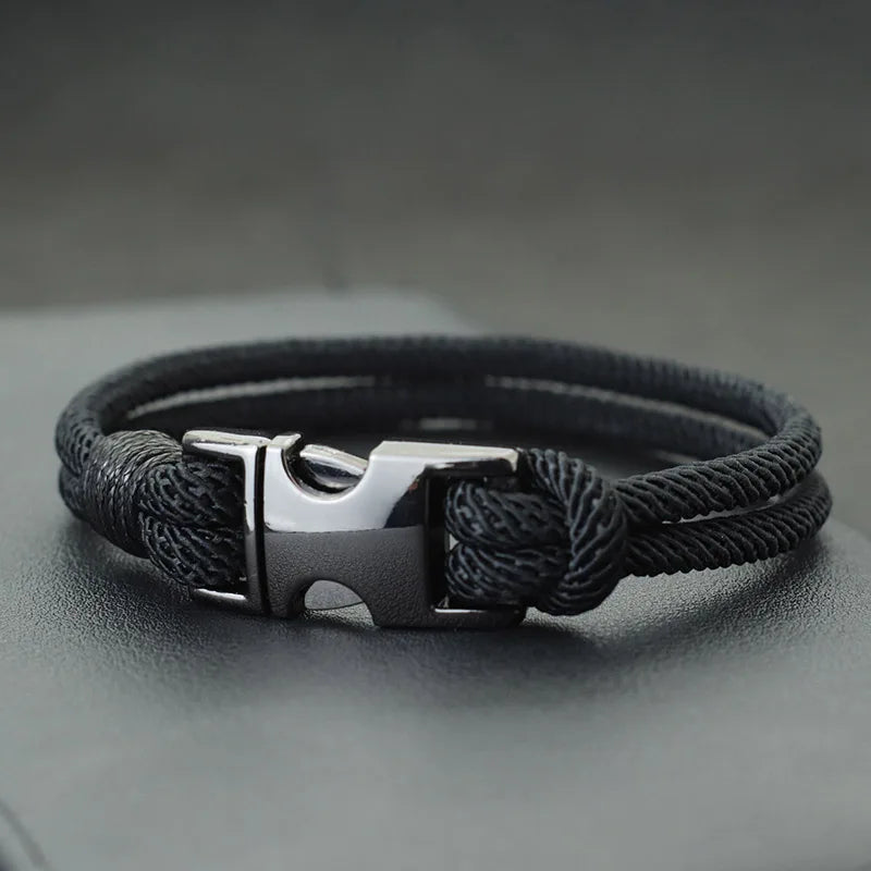Black double-strand rope bracelet with a gunmetal spring-loaded buckle clasp