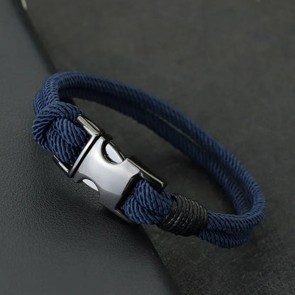 Navy double-strand rope bracelet with a gunmetal spring-loaded buckle clasp