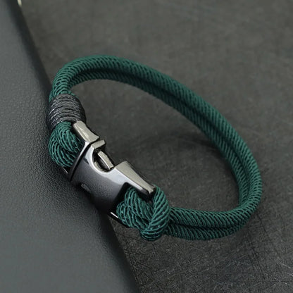 Green double-strand rope bracelet with a gunmetal spring-loaded buckle clasp