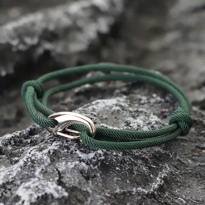 Green nylon rope bracelet double-wrapped with a curved metal hook clasp