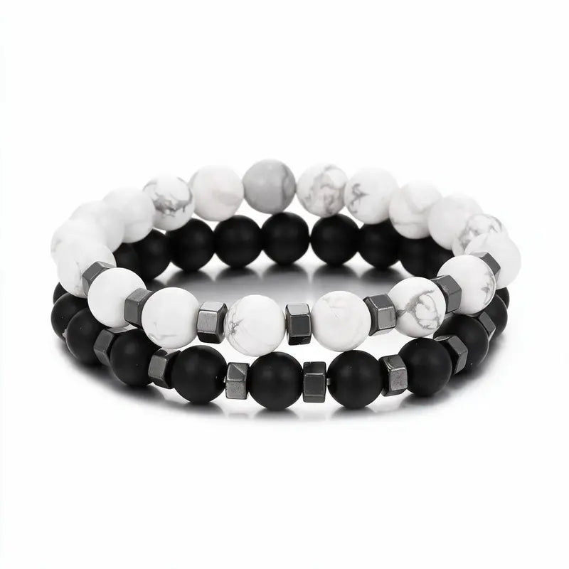 White howlite and matte black onyx bead bracelet set with hematite spacers, product photo on white background