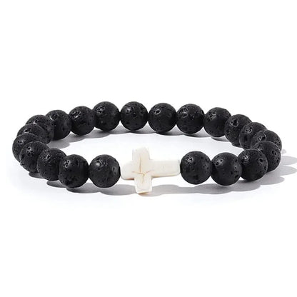 Black lava stone bead bracelet with a contrasting white cross bead