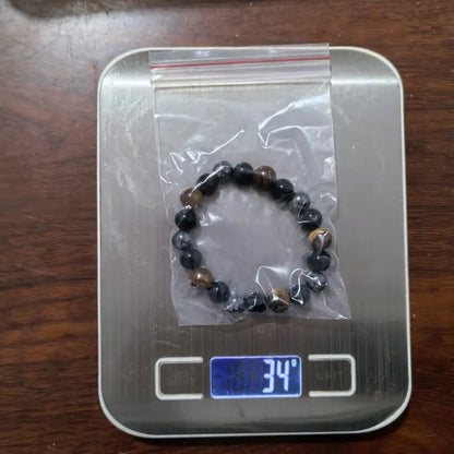Tiger eye, black obsidian and hematite bead bracelet, angled studio shot