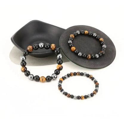 Three Triad Protection bracelets stacked together showing bead size range