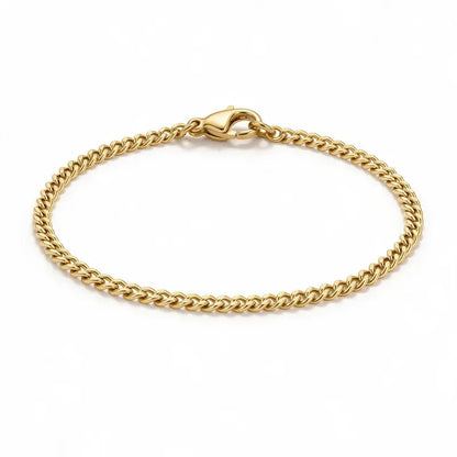 Astor gold slim Cuban curb chain bracelet, product photo on white background.