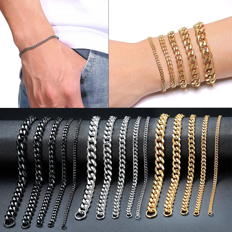 Black, silver and gold Cuban link chain bracelets in five widths, worn on the wrist and laid out on a leather surface