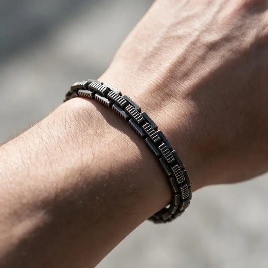 Dark oxidized stainless steel ridged box chain bracelet worn on the wrist