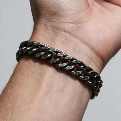 Colossus heavy oxidized Cuban double-curb link bracelet, worn on a man's wrist.