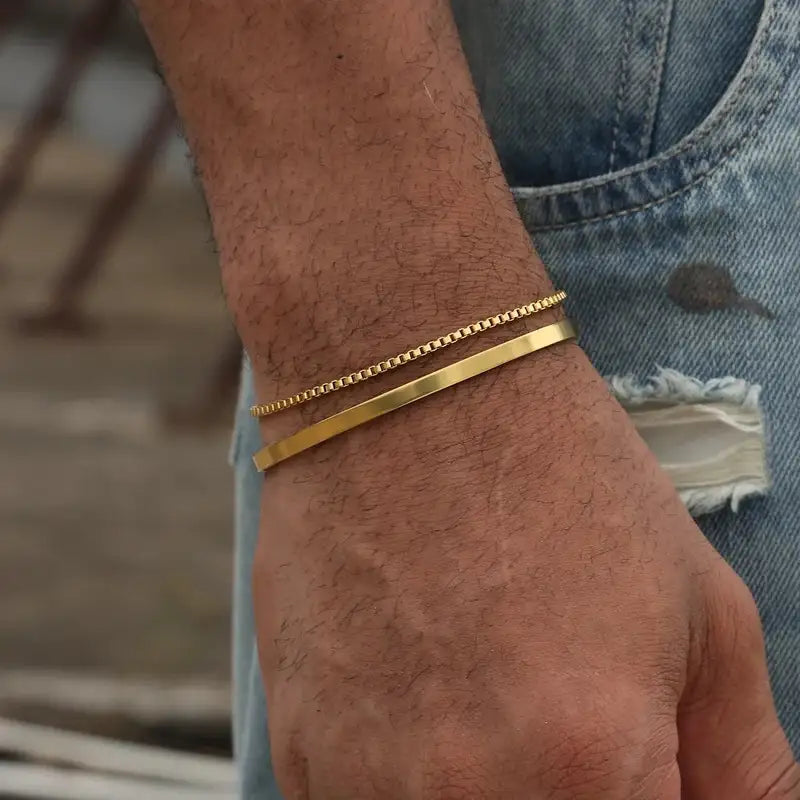 Gold box chain and flat bar bracelet worn on the wrist