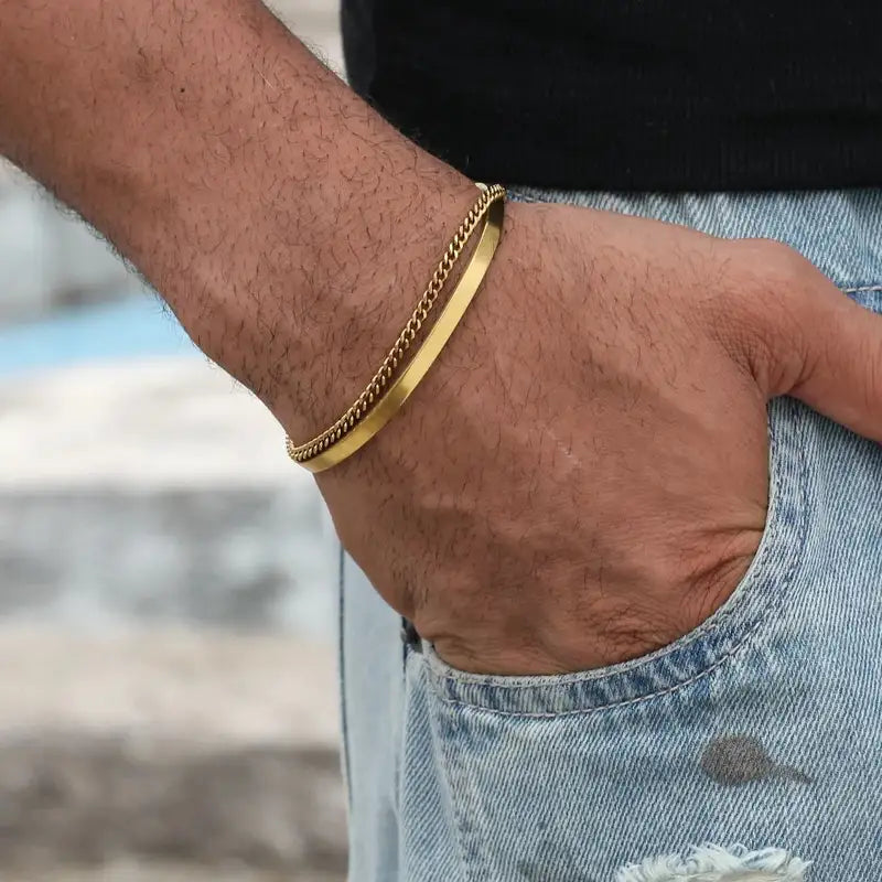 Gold curb chain and flat bar bracelet joined in one piece, worn on the wrist