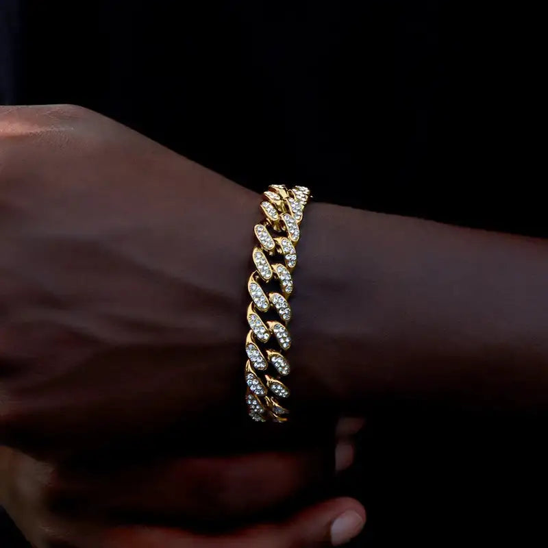 Gold iced-out Cuban link bracelet worn on the wrist