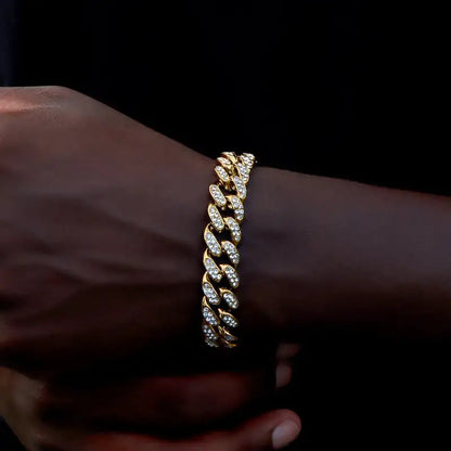 Gold iced-out Cuban link bracelet worn on the wrist