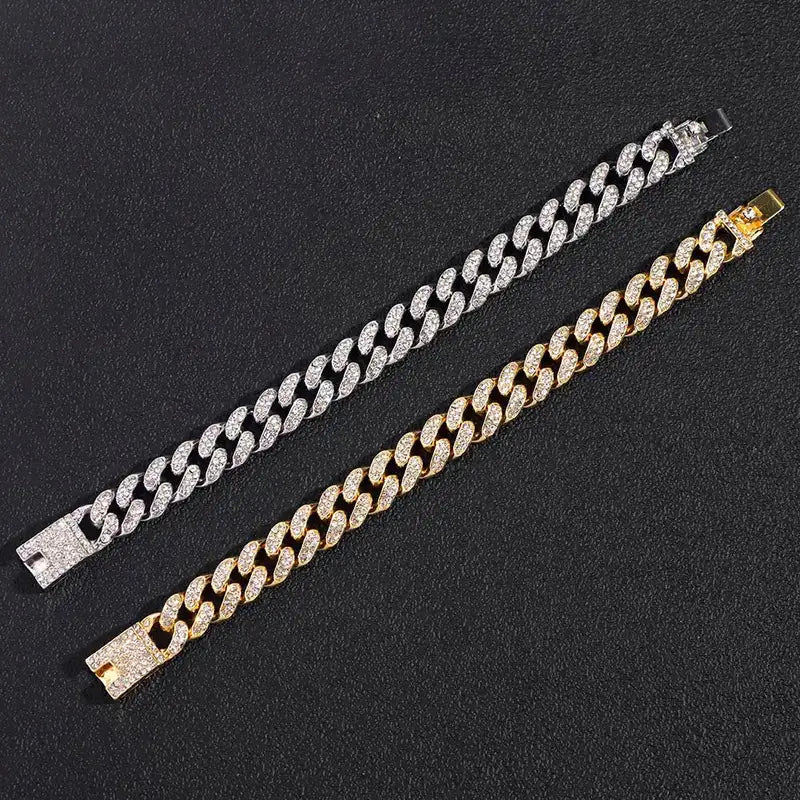 Silver and gold iced-out Cuban link bracelets laid flat, showing the sparkling clasps