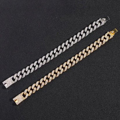 Silver and gold iced-out Cuban link bracelets laid flat, showing the sparkling clasps