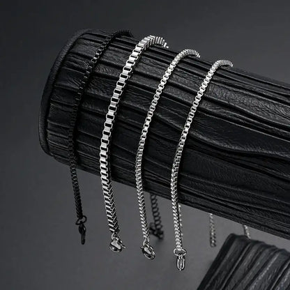 Silver and black box chain bracelets of different widths displayed together