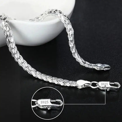 925 sterling silver scaled snake chain bracelet displayed with a small dish