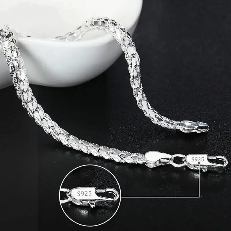 925 sterling silver scaled snake chain bracelet displayed with a small dish