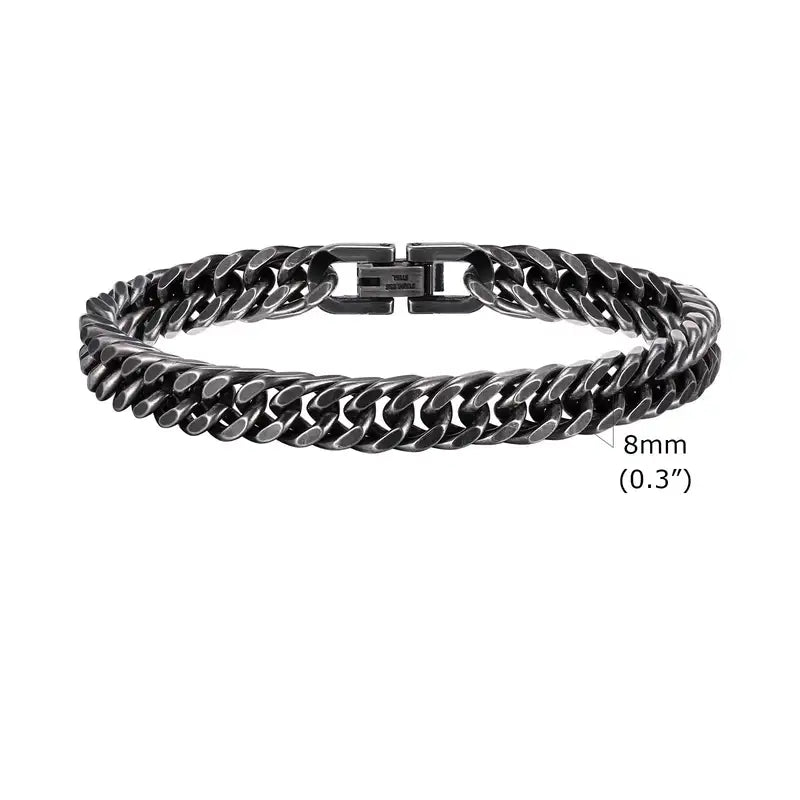 8mm oxidized gunmetal stainless steel Cuban link bracelet with matte antique finish, coiled flat on a white background