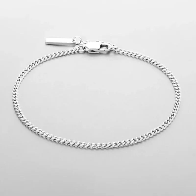 Minimalist gold Cuban chain bracelet featuring a polished stainless steel finish and secure lobster clasp.