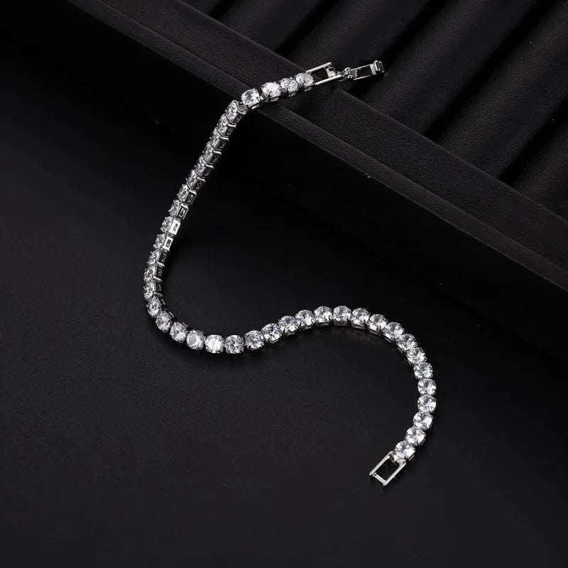 Gold tennis bracelet with premium crystal stones offering timeless elegance for parties and special occasions.