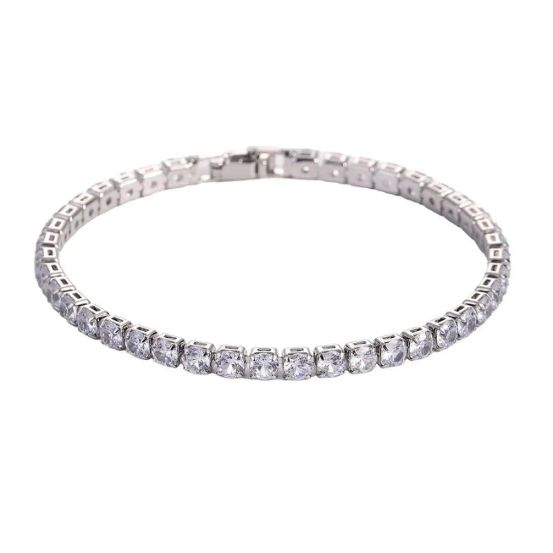Tennis bracelet with clear cubic zirconia stones in a silver setting, on a plain white background