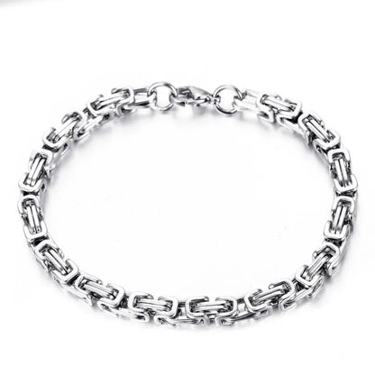 Silver-tone Byzantine box-chain bracelet laid flat in a circle on a plain white background.
