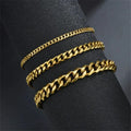 Three gold Cuban chain bracelets of increasing width draped around a black display cylinder, showing the range of available widths.