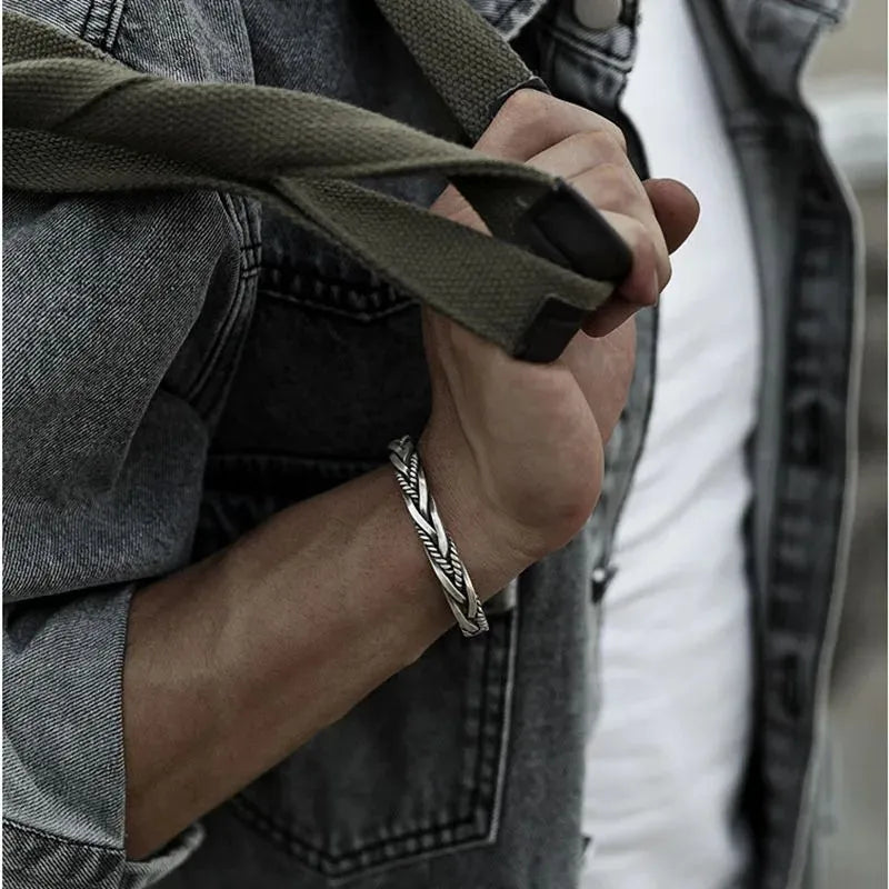 Handmade 925 sterling silver cuff bracelet showcasing an elegant twisted woven design for men.