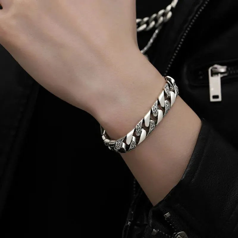 Close-up of the Men's Bracelet Silver featuring an engraved Cuban link chain with polished sterling silver.