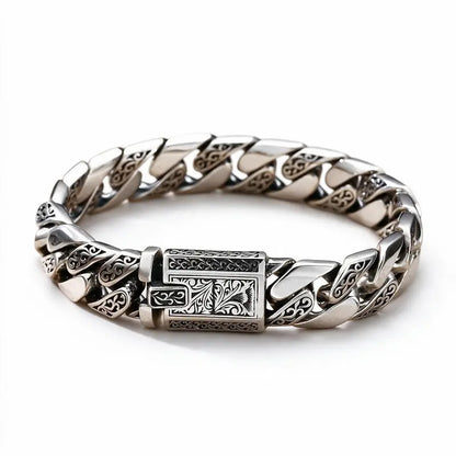 Engraved silver Cuban-link bracelet with an ornate rectangular clasp, on a plain white background.